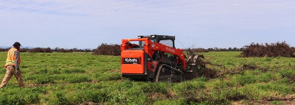 Tractor disc ripping an open field